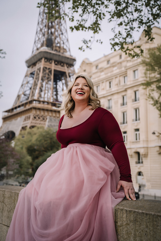 portraits of beautiful smiling women in front of the Eiffel Tower