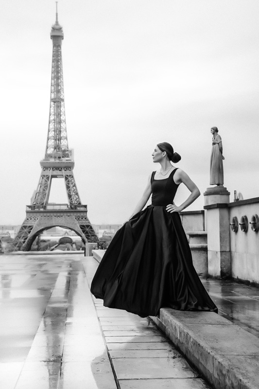 Classic black and white photo of a beautiful woman at the Eiffel Tower
